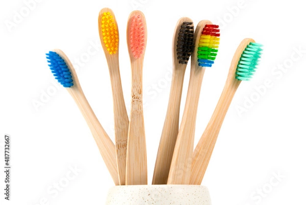 Fototapeta Close-Up Of Toothbrushes In Container Against White Background