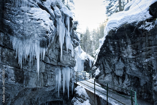 Fototapeta Breitachklamm Alps - snow and dramatic frozen ice covered paths within a gorge and mountains 
