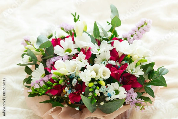 Fototapeta .Bouquet of spring flowers on a light background. Postcard. Place for text. March 8. Valentine's Day.