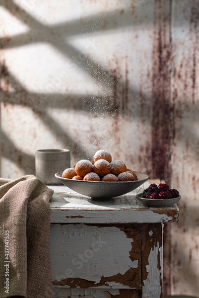 Fototapeta Fresh delicious homemade cottage cheese ball donuts with powdered sugar. Powdered sugar is poured for dessert. Rustic style,