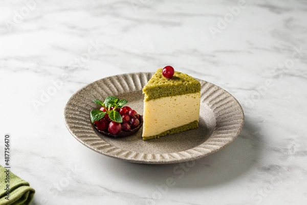 Fototapeta  Milk souffle bird's milk cake with fresh with cranberries and mint on white background. Sponge cake with matcha tea and tender souffle, creamy mousse