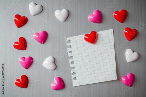 Fototapeta Abstract of wooden heart clip with Blank paper and stick paper on refrigerator door. paper note copy space for add text. valentine picture message background