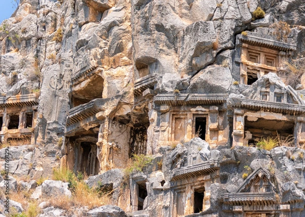 Fototapeta Rock-cut Lycian tombs in Myra. Ancient necropilis. Close up view. Open air museum in Demre (Turkey). Famouse tourist attraction, very pupular tour. Travel of history concept