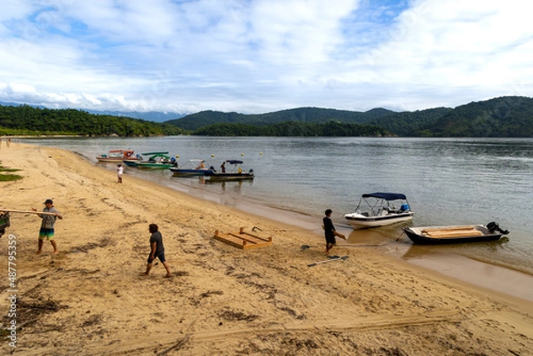 Obraz men working on the beach sand