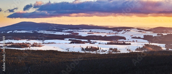 Fototapeta A colorful sunset in the Polish mountains of the Sudetes, the view from the top of the mountain from the Czerniec observation tower, winter evening.