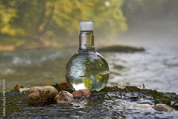 Fototapeta Flask with clear river water.