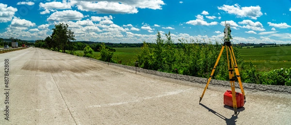 Fototapeta Surveyors equipment (theodolite or total positioning station) on the construction site of the road, highway or building