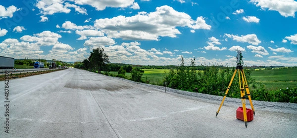 Fototapeta Surveyors equipment (theodolite or total positioning station) on the construction site of the road, highway or building