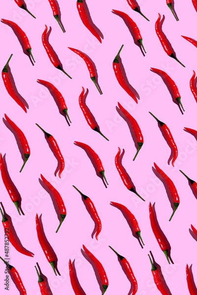 Obraz pattern of red hot chili peppers on a pink background. Top view. Flat lay. Wallpaper with fresh red hot chili peppers. Red chili peppers  on a pink background.