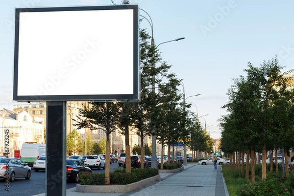 Fototapeta Empty billboard on the background of the highway and square in the urban space. Mock-up.