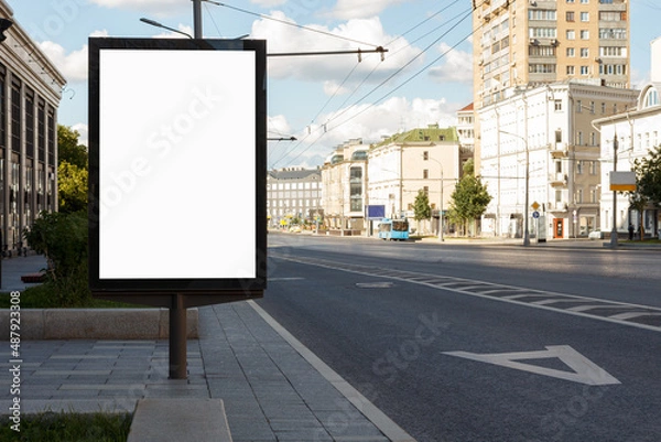 Fototapeta Empty billboard in the city on a bright sunny day. Highway, no cars, lunch time. Mock-up.