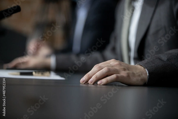 Fototapeta Businessman or politician giving inteview. Close up view gesticulating hands of business man.