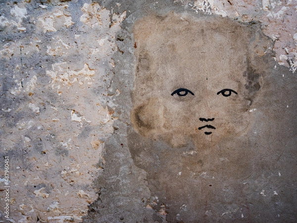 Fototapeta silhouette of a child's face on the fence
