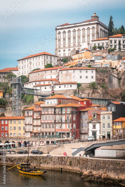 Fototapeta Old town of Oporto from the bridge of San Luis, with the river and a boat in the foreground, and the Cathedral and the Diocese of Oporto in the background.