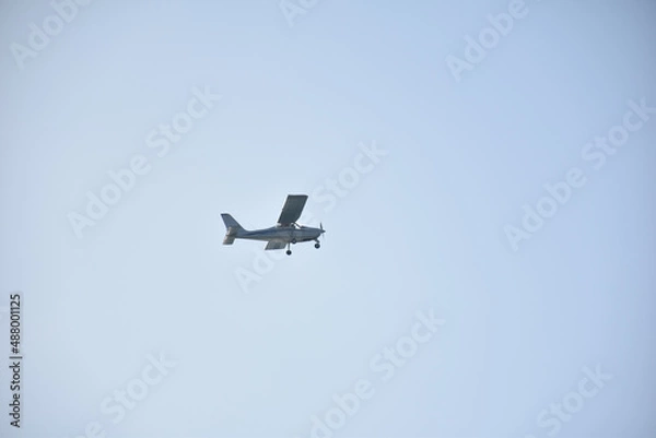 Fototapeta Perspective view of light aircraft in flight
