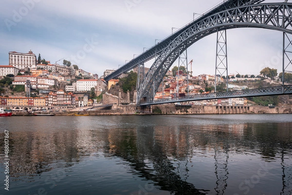 Fototapeta Views of the city of Porto from the Douro river with the Dom Luis I bridge in the foreground.