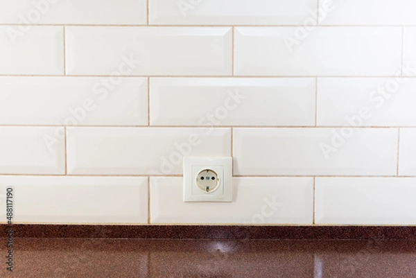 Obraz EU socket on the wall of tiled tiles in the kitchen