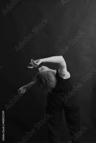 Fototapeta The dancer girl dances and expresses herself through the body