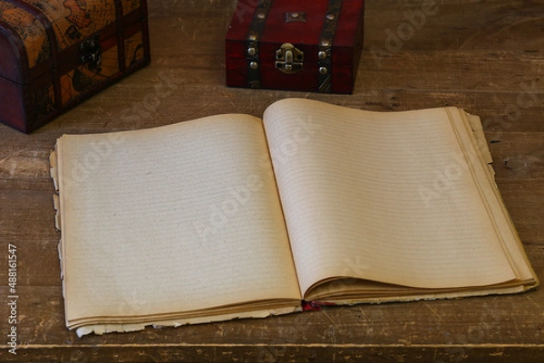 Fototapeta an open, clean old notebook for writing on an old wooden table