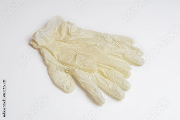 Obraz White medical gloves on a white background. Rubber medical gloves. Individual protection means.