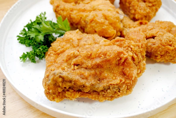 Fototapeta Close Up of a Southern Fried Chicken Thigh on a White Plate
