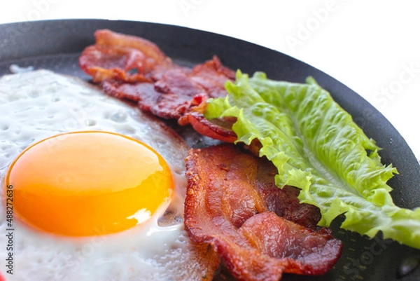 Obraz the fried egg, fried eggs, bacon meat, a lettuce leaf, food, a breakfast on a white background