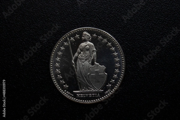 Fototapeta metal coin close-up on a black background.