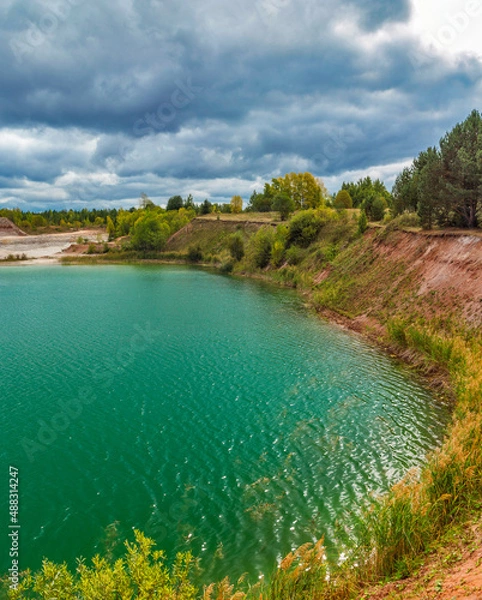 Fototapeta lake in the limestone quarry on a cloudy gloomy summer day