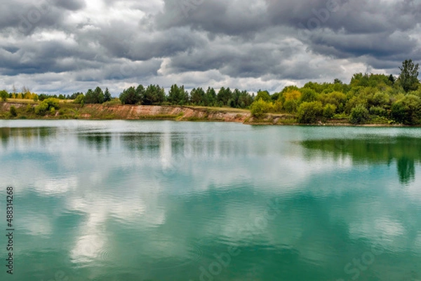 Fototapeta lake in the limestone quarry on a cloudy gloomy summer day