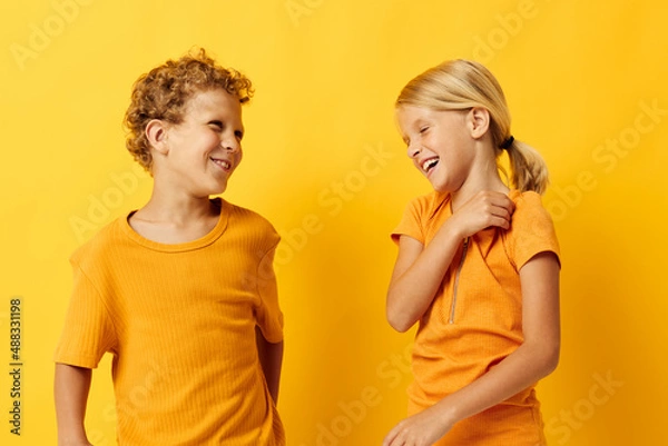 Fototapeta two joyful children casual wear games fun together posing isolated background unaltered