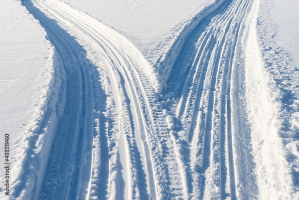 Fototapeta Two snowmobile roads close-up.