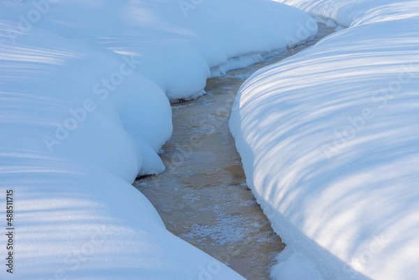 Obraz Frozen small river with high snow banks