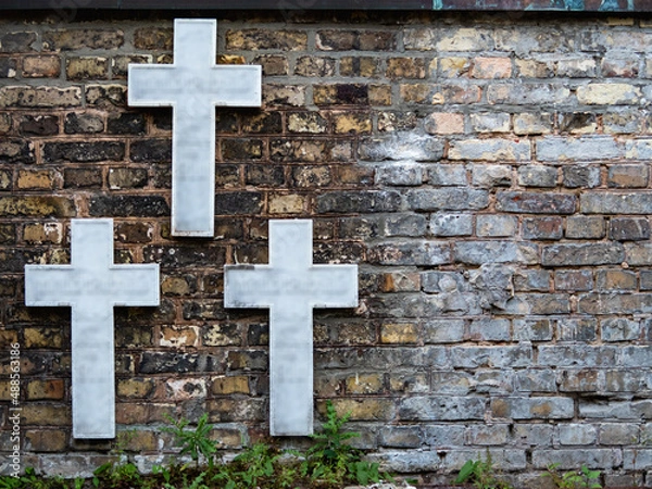 Obraz three white crosses on a brick wall