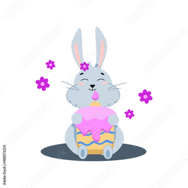 Fototapeta gray easter bunny sits with a cake with a candle