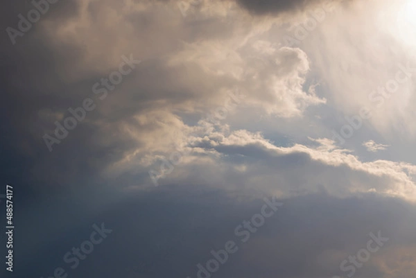 Fototapeta A sunbeam through the clouds. Dramatic sky. Natural background.