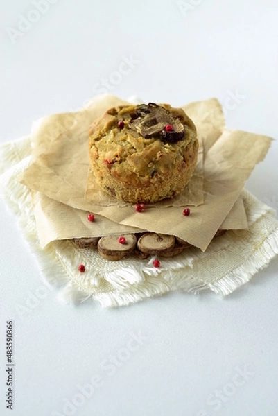 Fototapeta Muffin with mushrooms and cheese on cornmeal, snack muffin, vertical