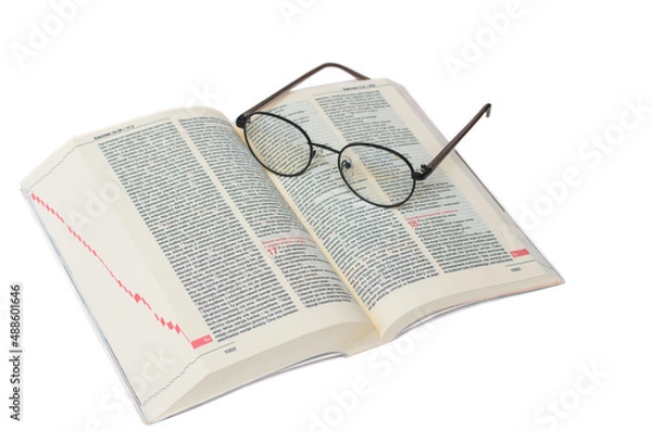 Obraz Glasses lying on the Bible in Polish isolated on a white background