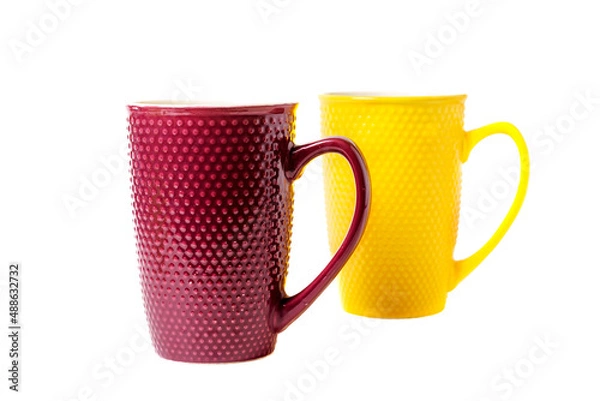 Obraz Red and yellow cups on a white background.
