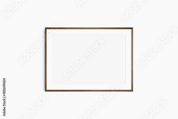 Obraz Horizontal frame mockup 7:5, 70x50, A4, A3, A2, A1 landscape. Single dark brown walnut wood frame mockup. Clean, modern, minimalist, bright. Passepartout/mat opening in 3:2 aspect ratio.