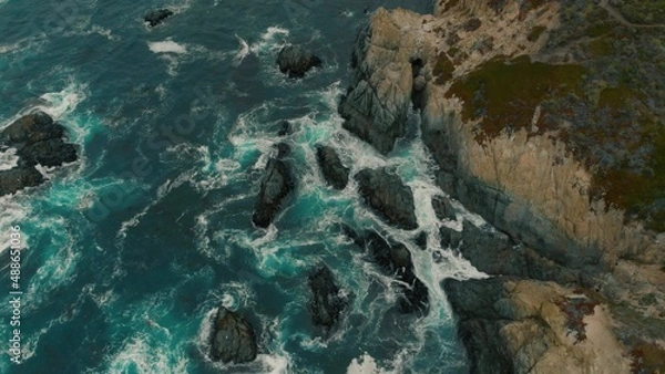 Obraz Crystal clear turquoise water, waves crashing on the rocky shore, and the ruins