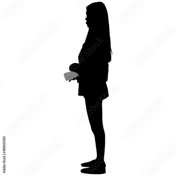 Fototapeta Black silhouette of slender woman in trousers with long hair with phone in her hand