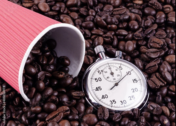 Obraz Paper cup of red color and times on a background of coffee beans