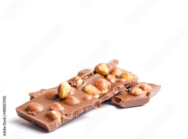 Obraz Pieces of chocolate with hazelnuts on a white background