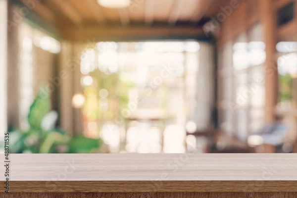 Obraz Wooden table top with blurred people in coffee shop and cafe background for display montage, copy space.