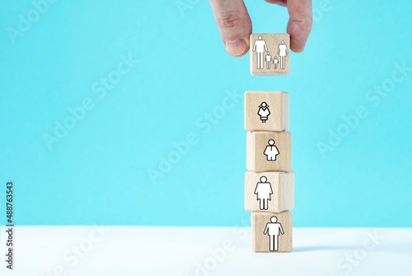 Fototapeta Hand puts a dice with family symbol