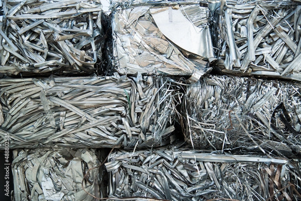 Obraz Large tracked excavator working a steel pile at a metal recycle yard. Industrial scrap metal recycling - selective focus, copy space