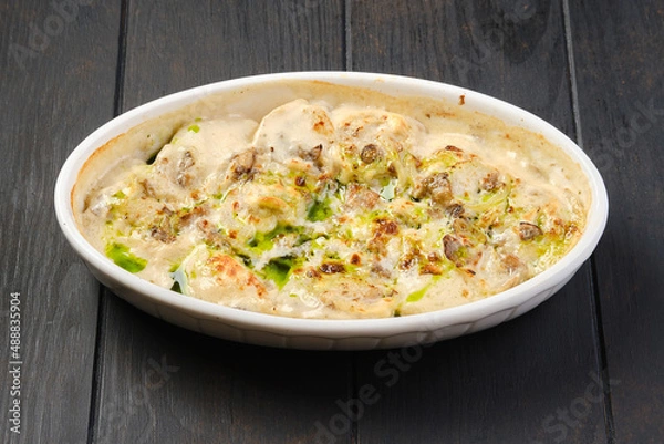 Fototapeta Chicken dumplings with onion sauce baked in oven