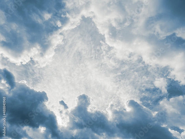 Fototapeta Background of cloud layers on blue sky surrounding a central open space.