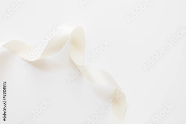 Fototapeta loops of white ribbon on gray text place.