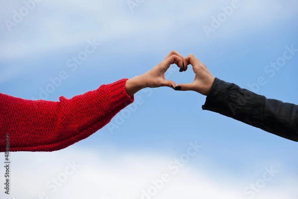 Obraz hape of the heart made by female hands isolated on blue